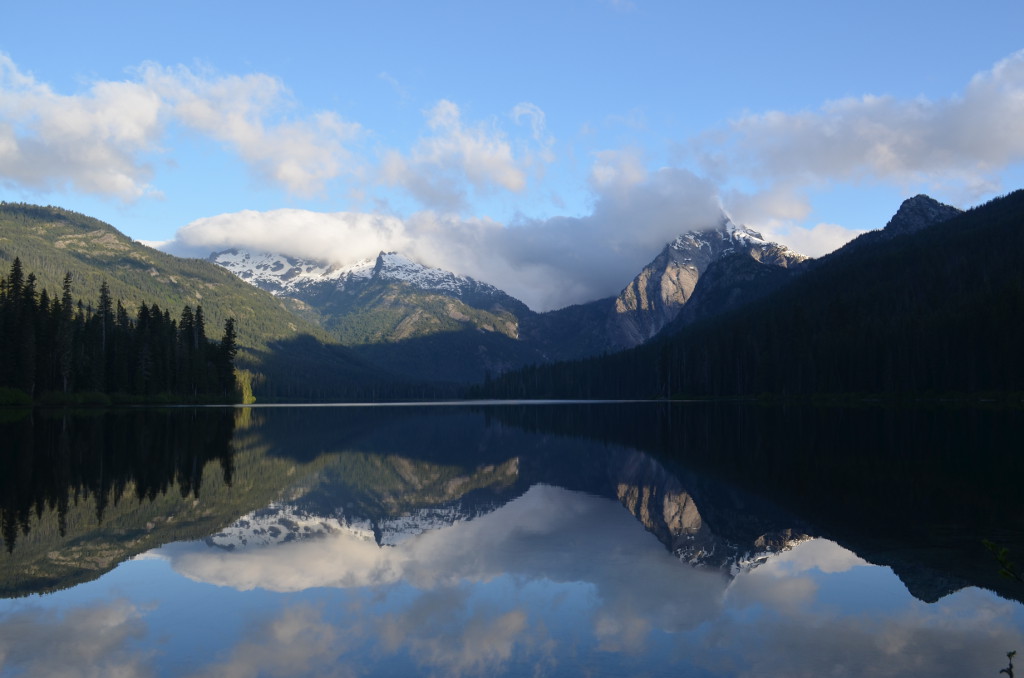 Lake Waptus in the morning, reflecting the nearby mountains.