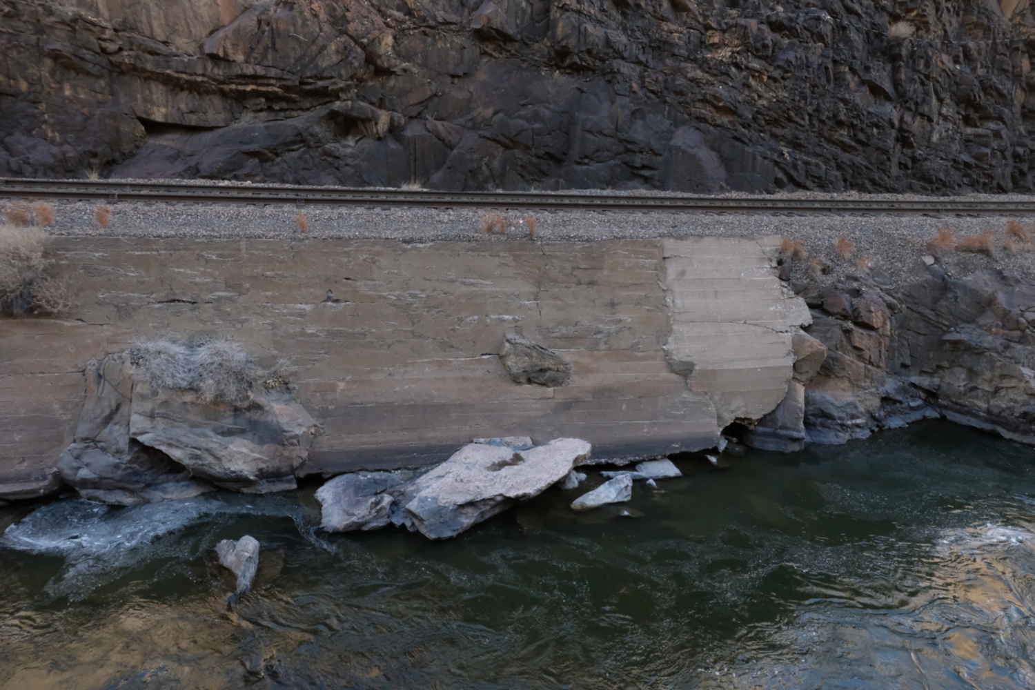 Rail track between clif and river.