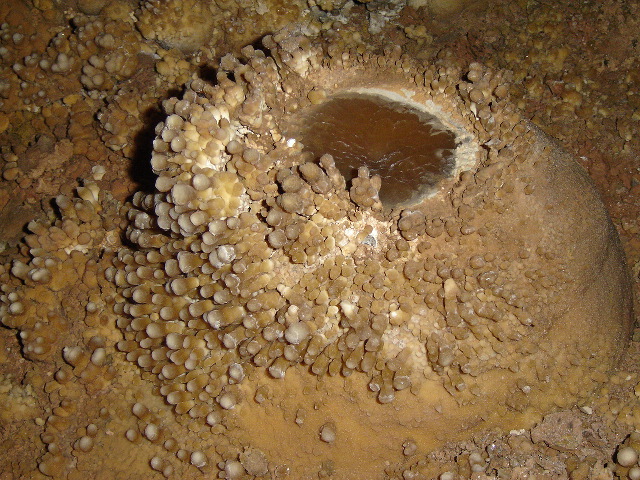 A strange popcorn / stalagmite / pool deposit / cave velvet formation.